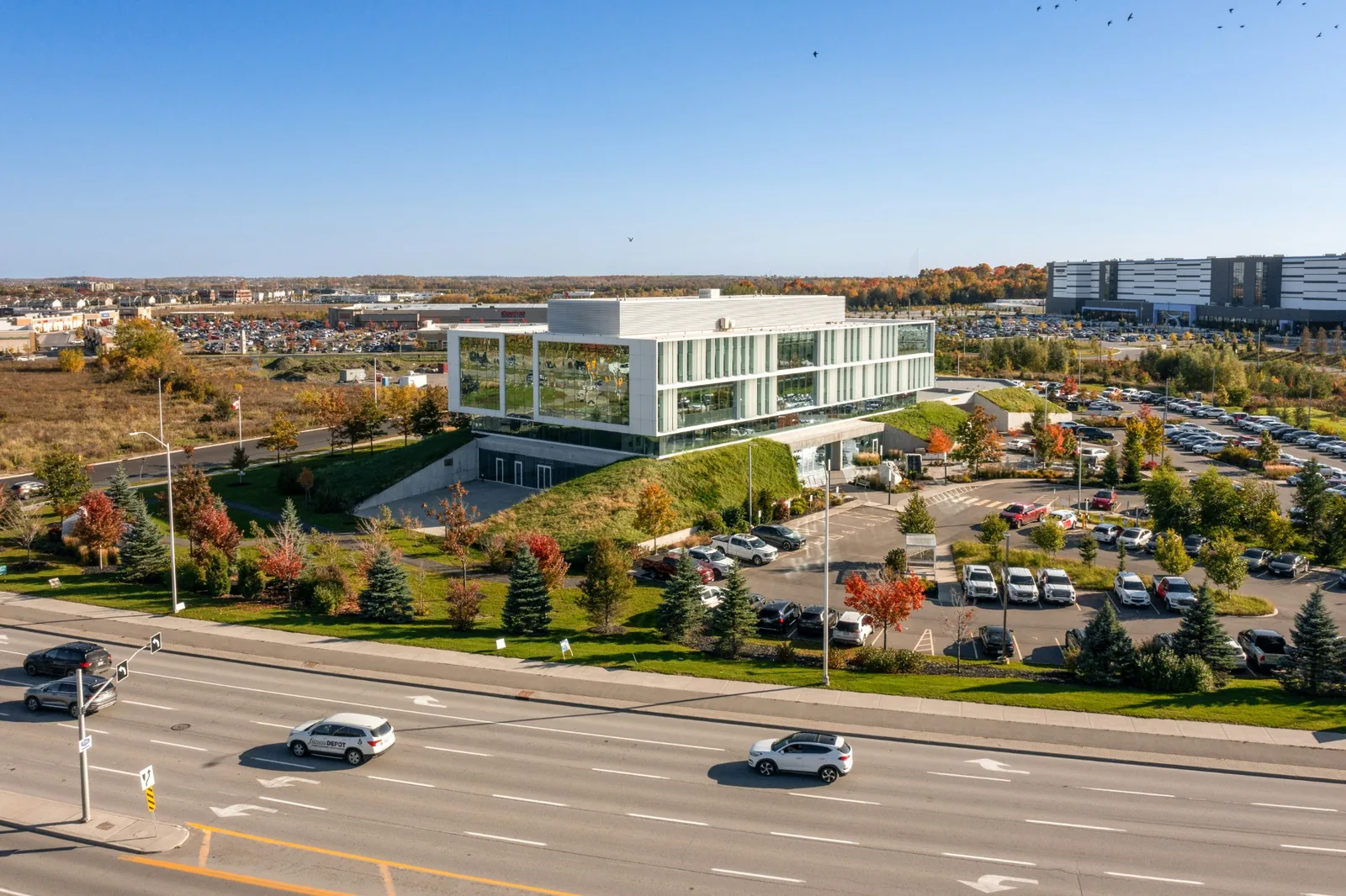 Reference aerial view of a modern office building next to a road